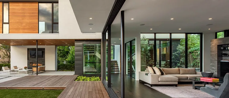 Modern home with a wall of glass opened onto the garden