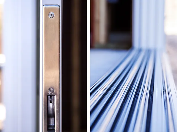 Close-up of the locking hardware and weather seal on a vinyl door