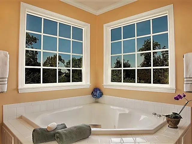 Corner bath with a pair of grid windows
