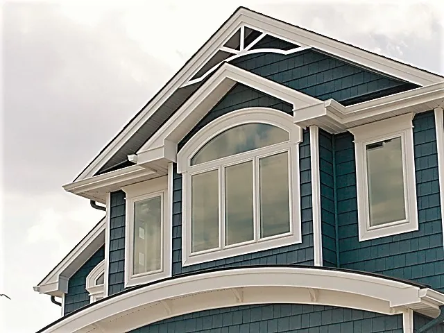Arched shape window mulled above a picture window in a gable