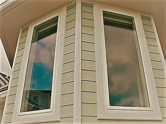 Angled bay of shape windows on a stucco wall