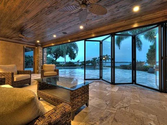Folding glass doors opened to the water from a covered patio