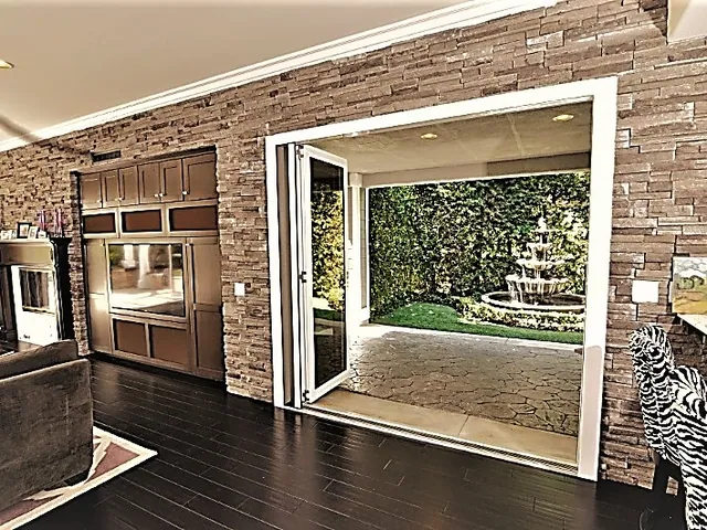 Folding doors part-open onto a planted courtyard