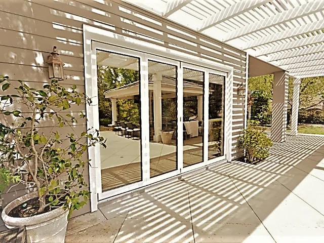 Multi-panel glass wall along a covered walkway