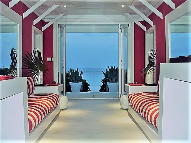 Folding doors opening a poolside room to the view