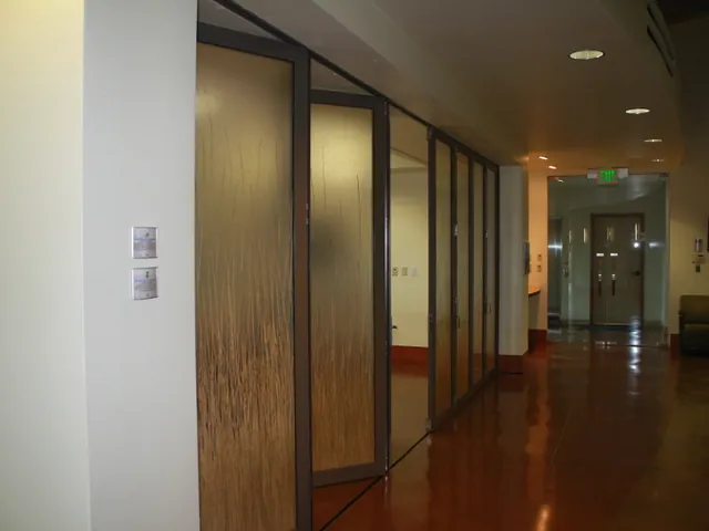 Interior glass partition wall in a corridor