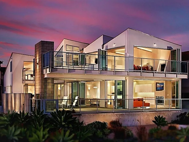 Contemporary home lit at dusk through large glazing