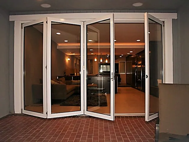 Bi-fold glass doors folded open onto a brick terrace