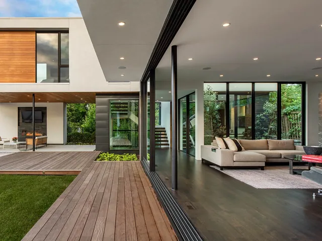 Modern home with a glass wall opened onto the lawn