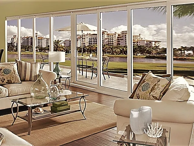 Living room with wide windows to a golf-course view