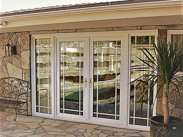 French sliding doors with sidelites in a stone wall
