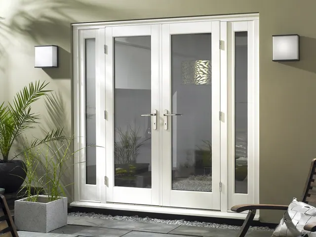 White French swing doors with planters either side