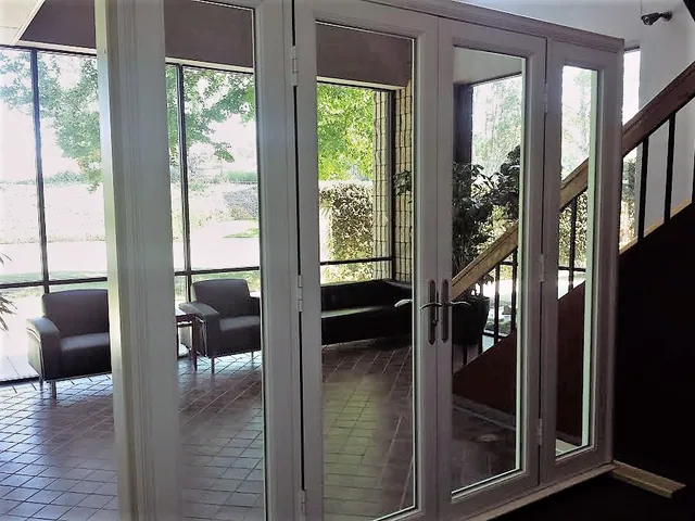 Dark-framed French doors from an interior stair