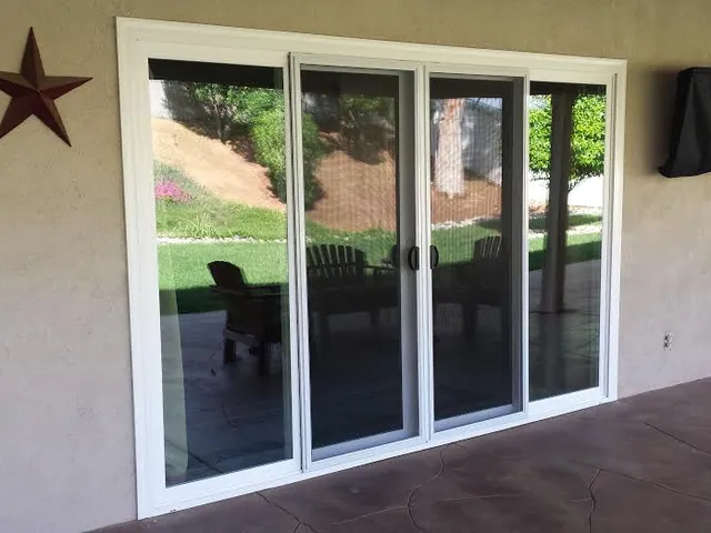 Multi-panel patio slider on a stucco rear elevation