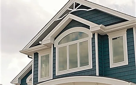 Arched shape window mulled above a picture window in a gable end