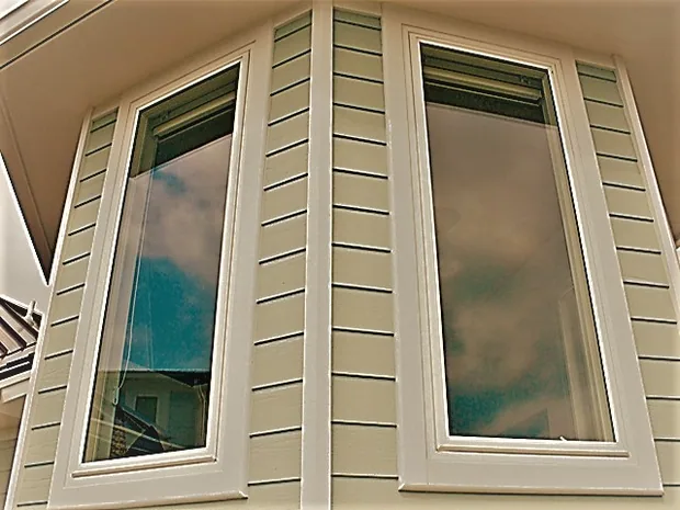 Angled bay of shape windows on a stucco elevation