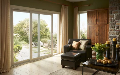 White vinyl sliding glass door in a living room with curtains drawn back